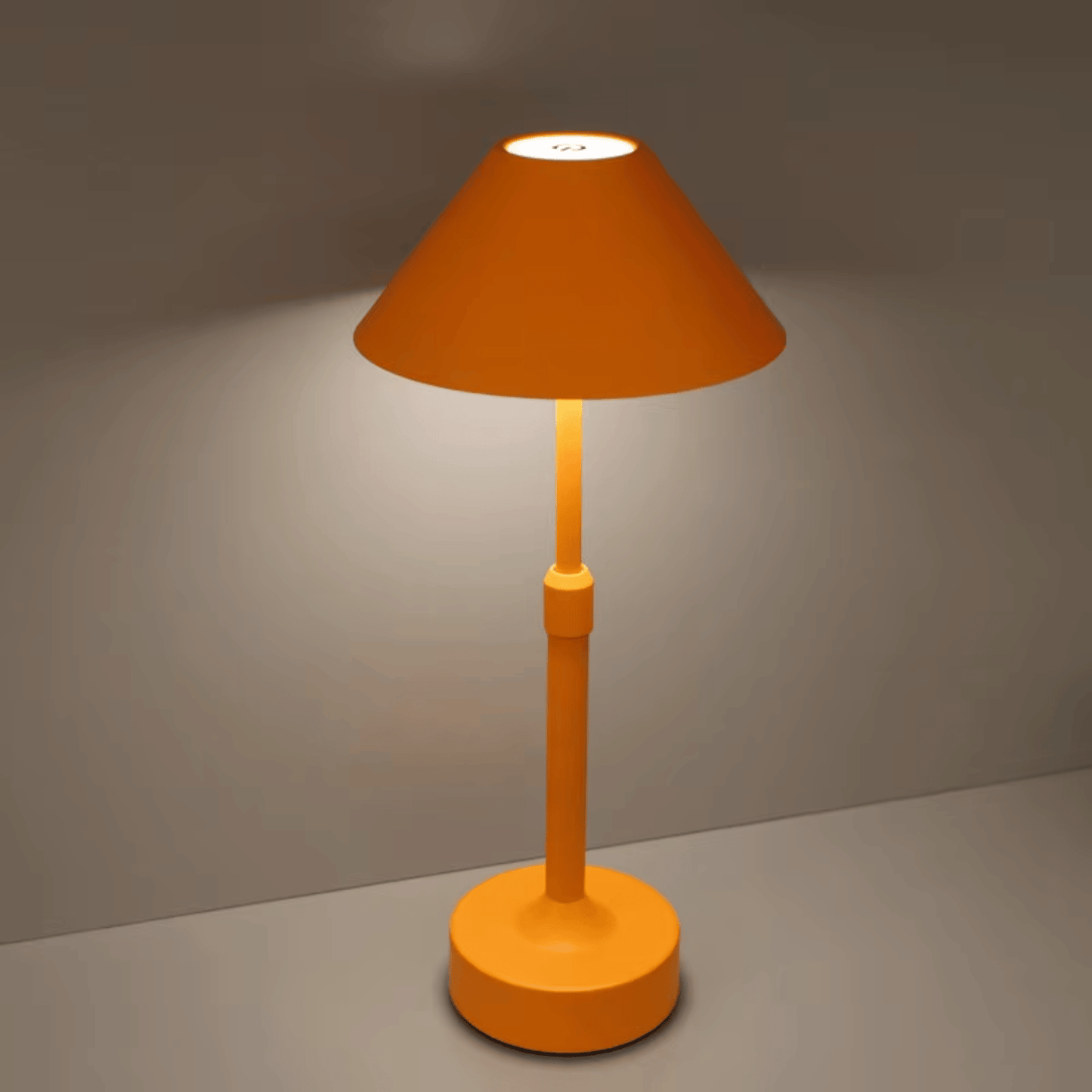 Orange table lamp on a gray surface with a dark background