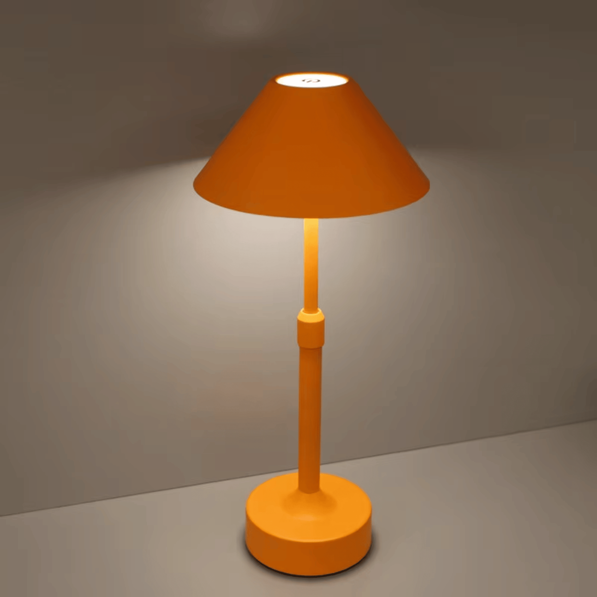 Orange table lamp on a gray surface with a dark background