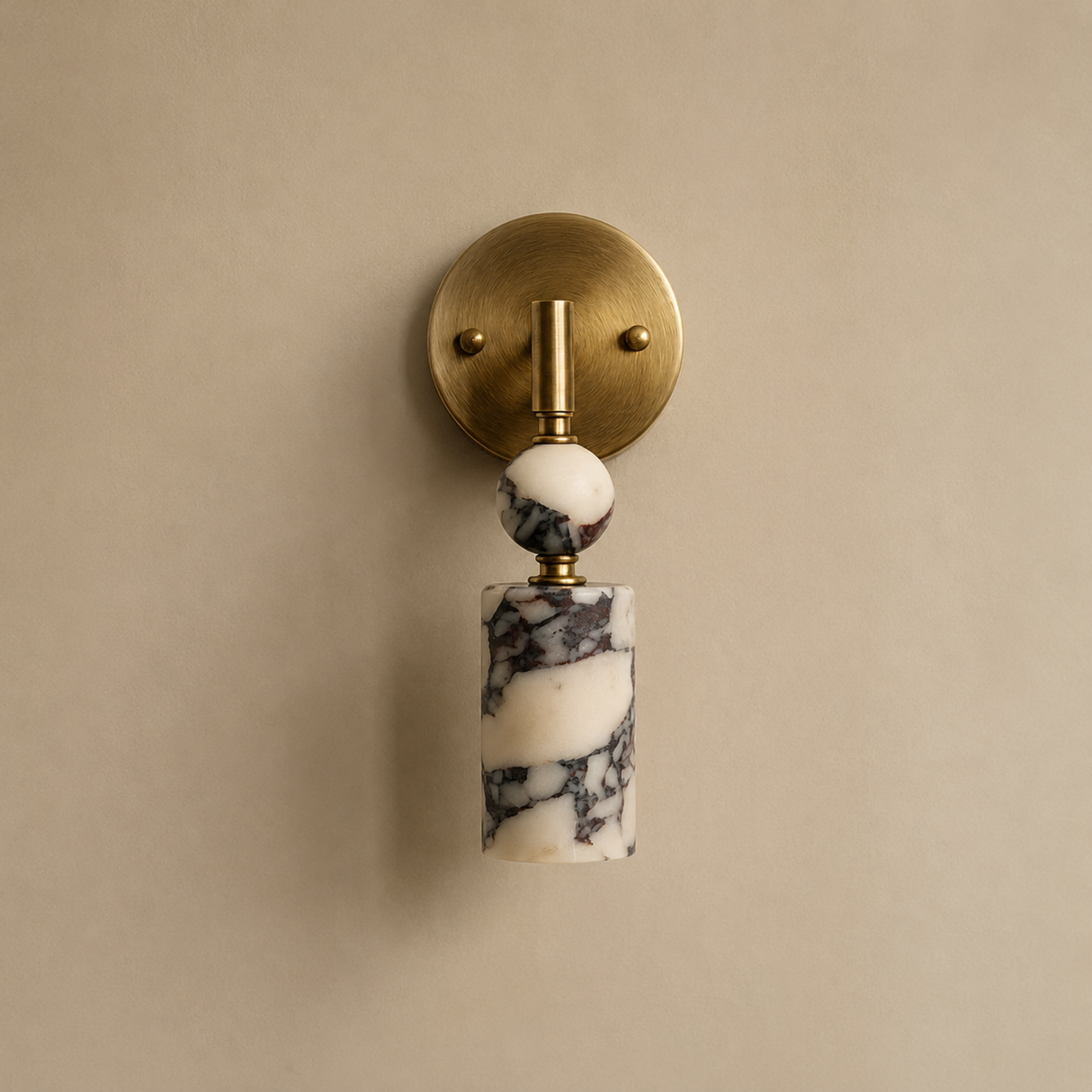 Wall sconce with marble base and brass fixture on a beige wall