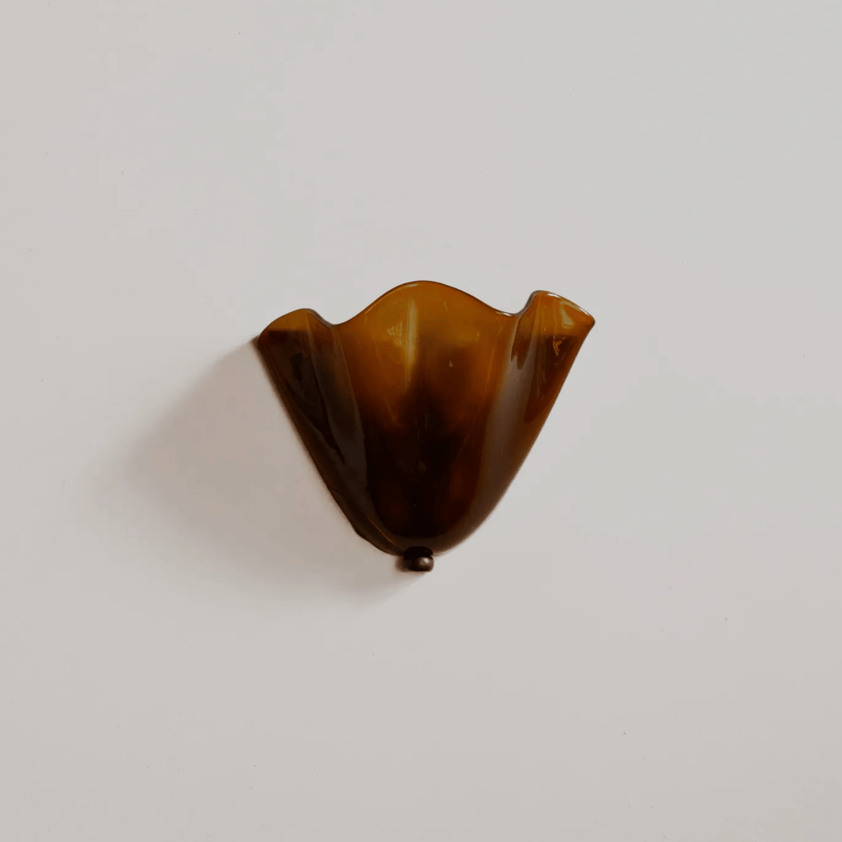 Brown glass object on a white background