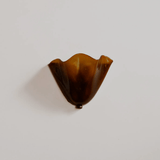 Brown glass object on a white background