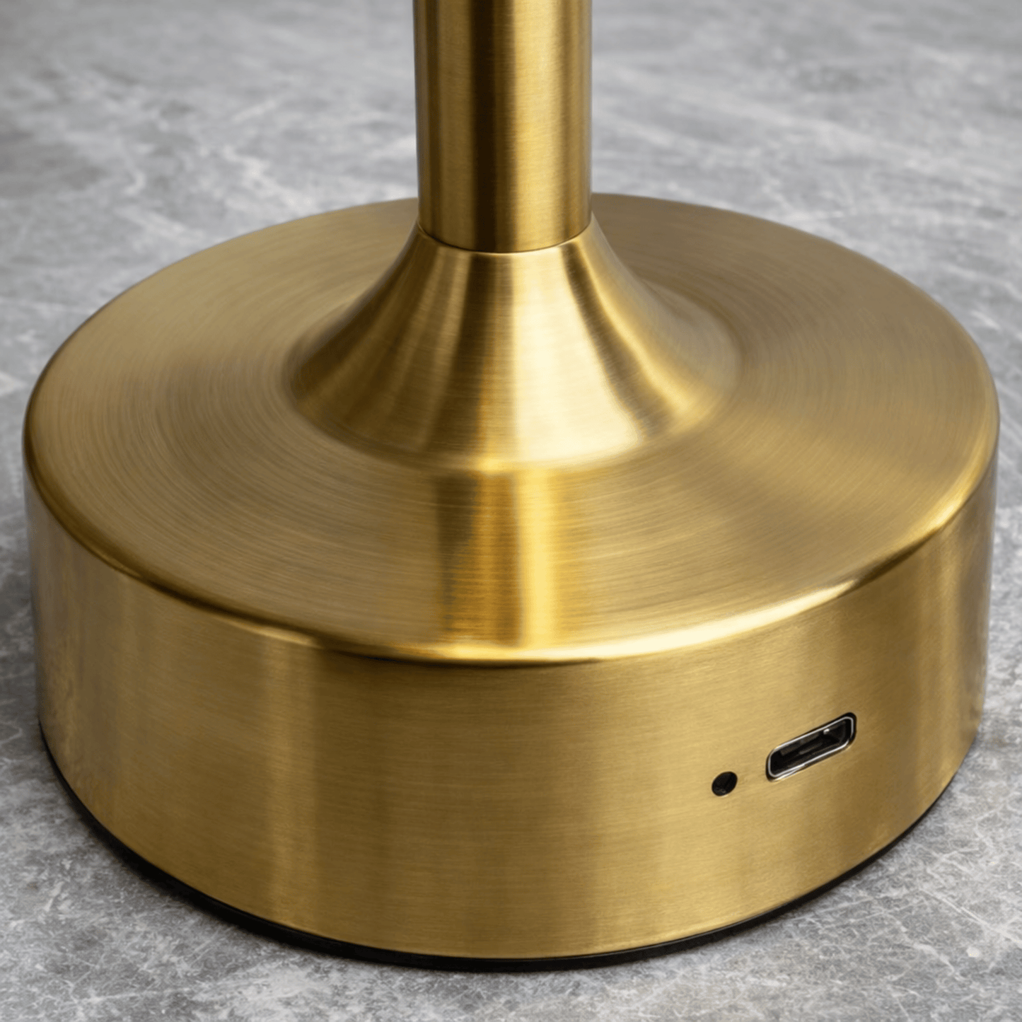 Gold cylindrical object with USB port on a gray surface