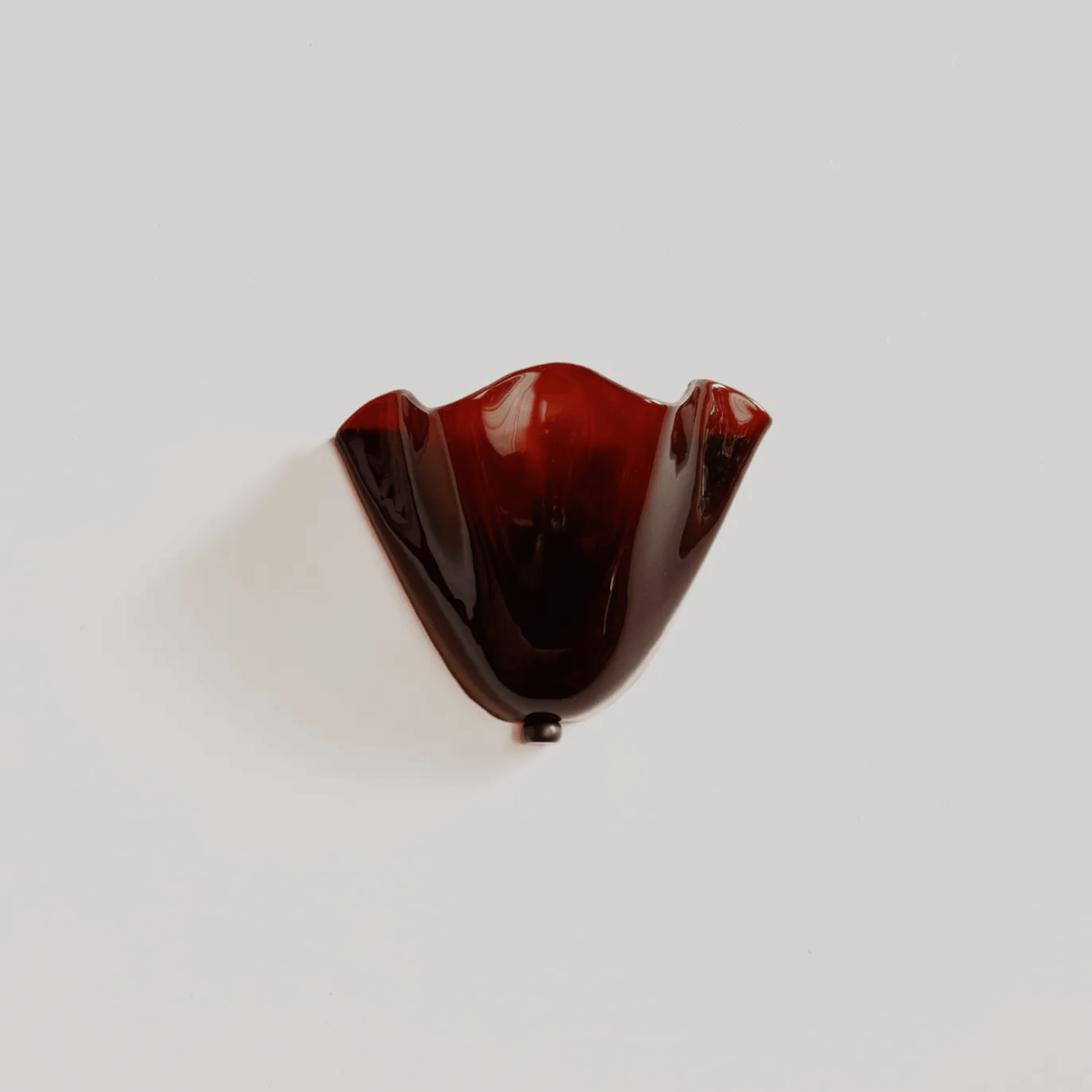 Brown glass object on a white background