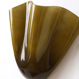 Glossy brown plastic object on a white background