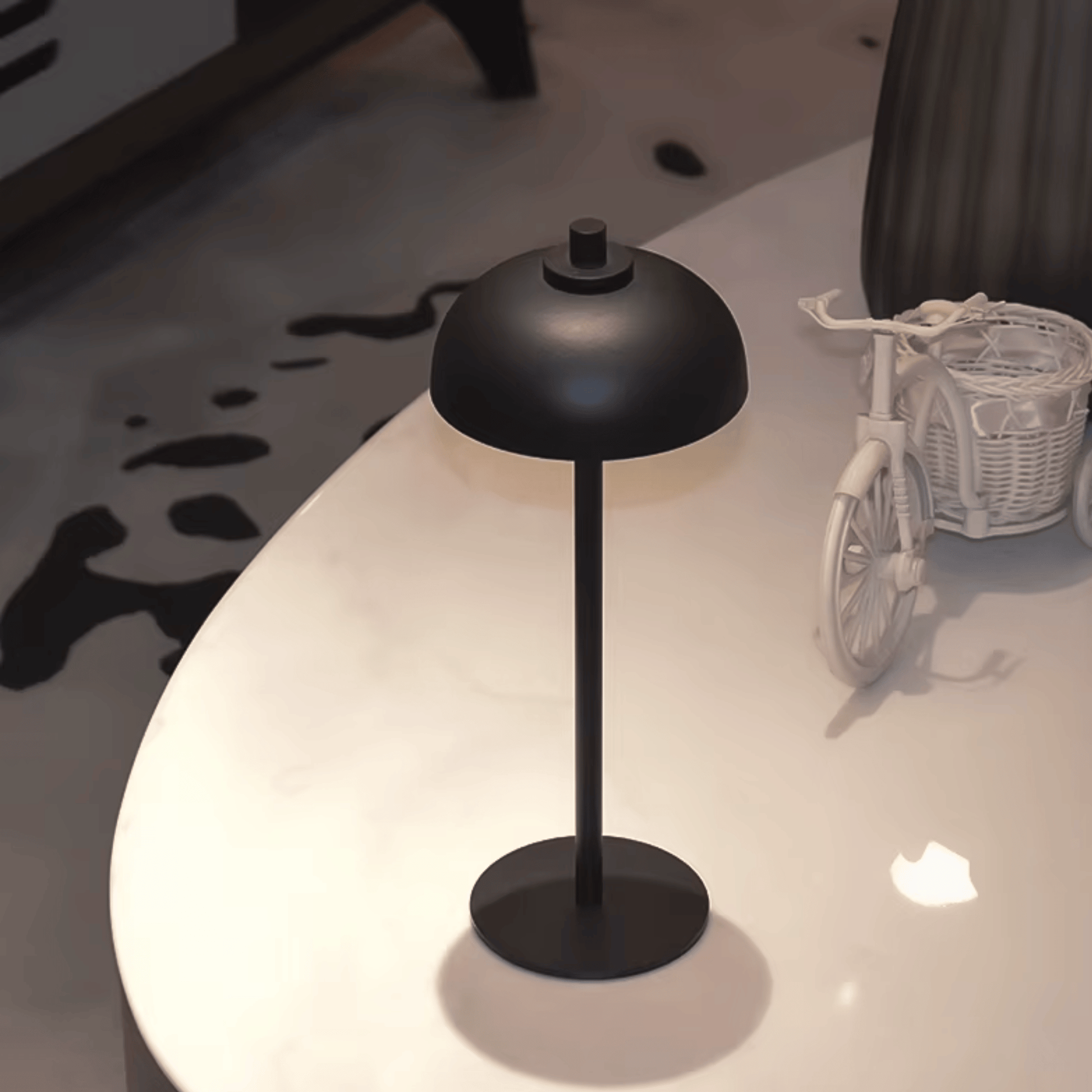 Black table lamp on a white surface with a blurred background