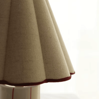 Close-up of a beige fabric skirt with a white background
