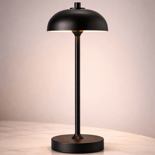 Black table lamp on a wooden surface with a neutral background