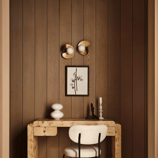 Wooden desk with chair against a brown paneled wall with decorative elements.