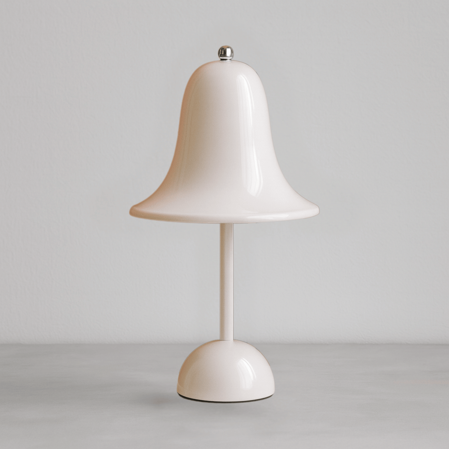 White table lamp with a bell-shaped shade on a gray background