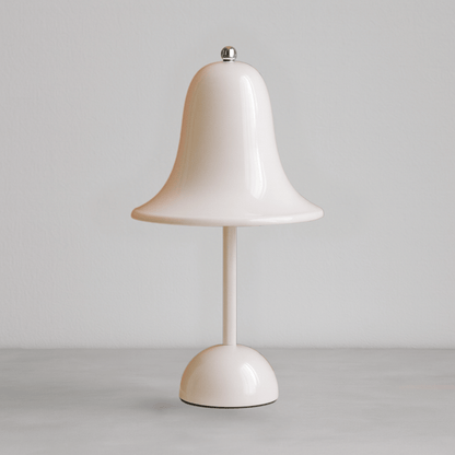 White table lamp with a bell-shaped shade on a gray background
