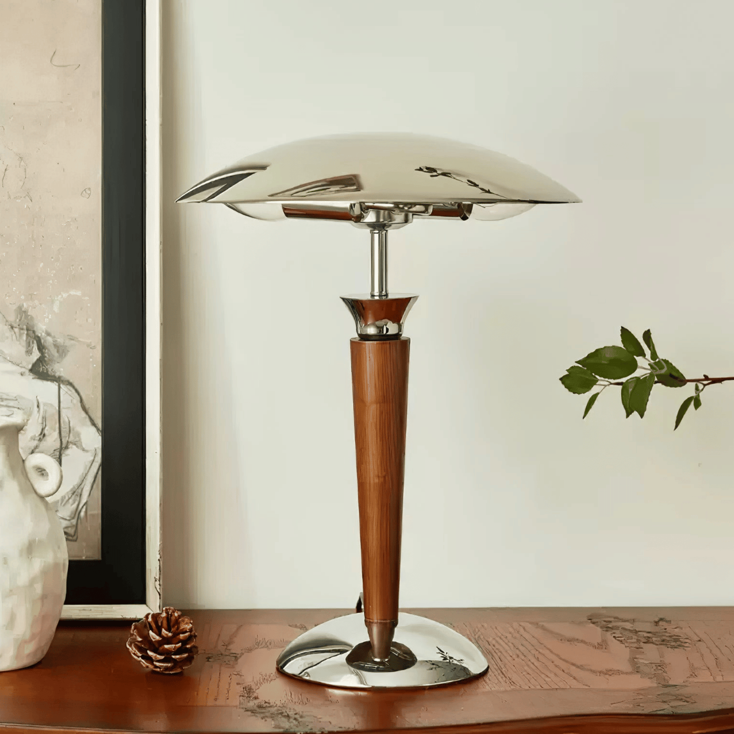 Table lamp with wooden base and glass shade on a wooden surface.