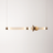 Modern pendant light with gold finish on a white background
