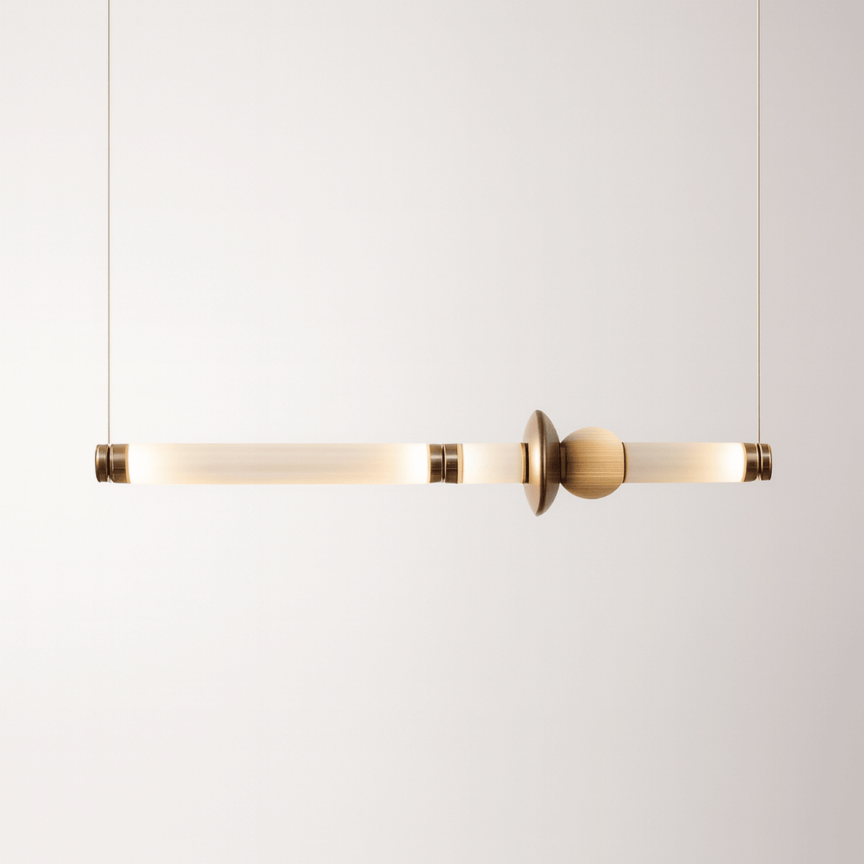 Modern pendant light with gold finish on a white background