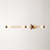 Modern pendant light with gold finish on a white background