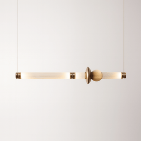 Modern pendant light with gold finish on a white background