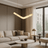 Modern living room with beige sofa, round coffee table, and pendant light.