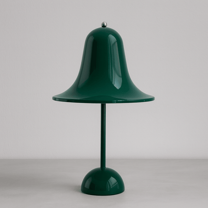 Green table lamp with a bell-shaped shade on a plain background