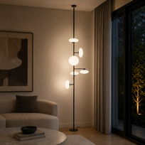 Modern floor lamp in a living room setting with a couch and abstract art.