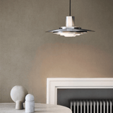 Modern pendant light fixture in a minimalistic room with a neutral color palette.
