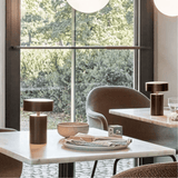 Modern dining room with marble table, chairs, and decorative items.