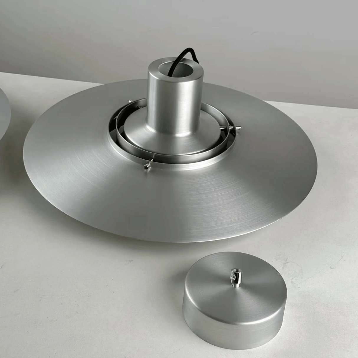 Metallic ceiling light fixture on a white background