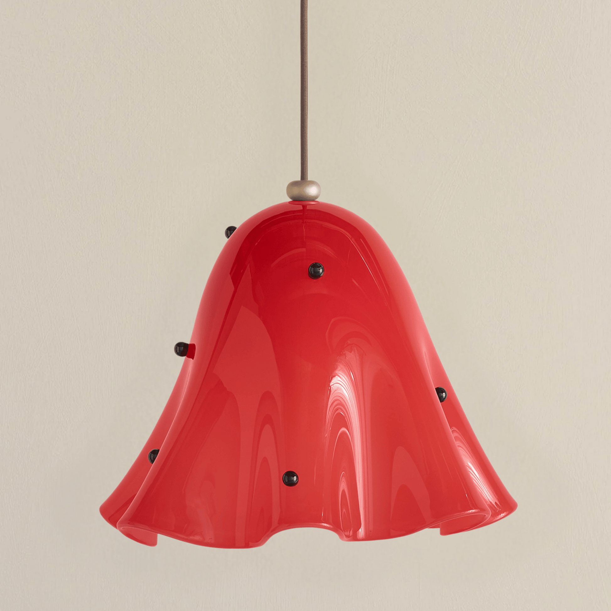 Red pendant light with a beige background