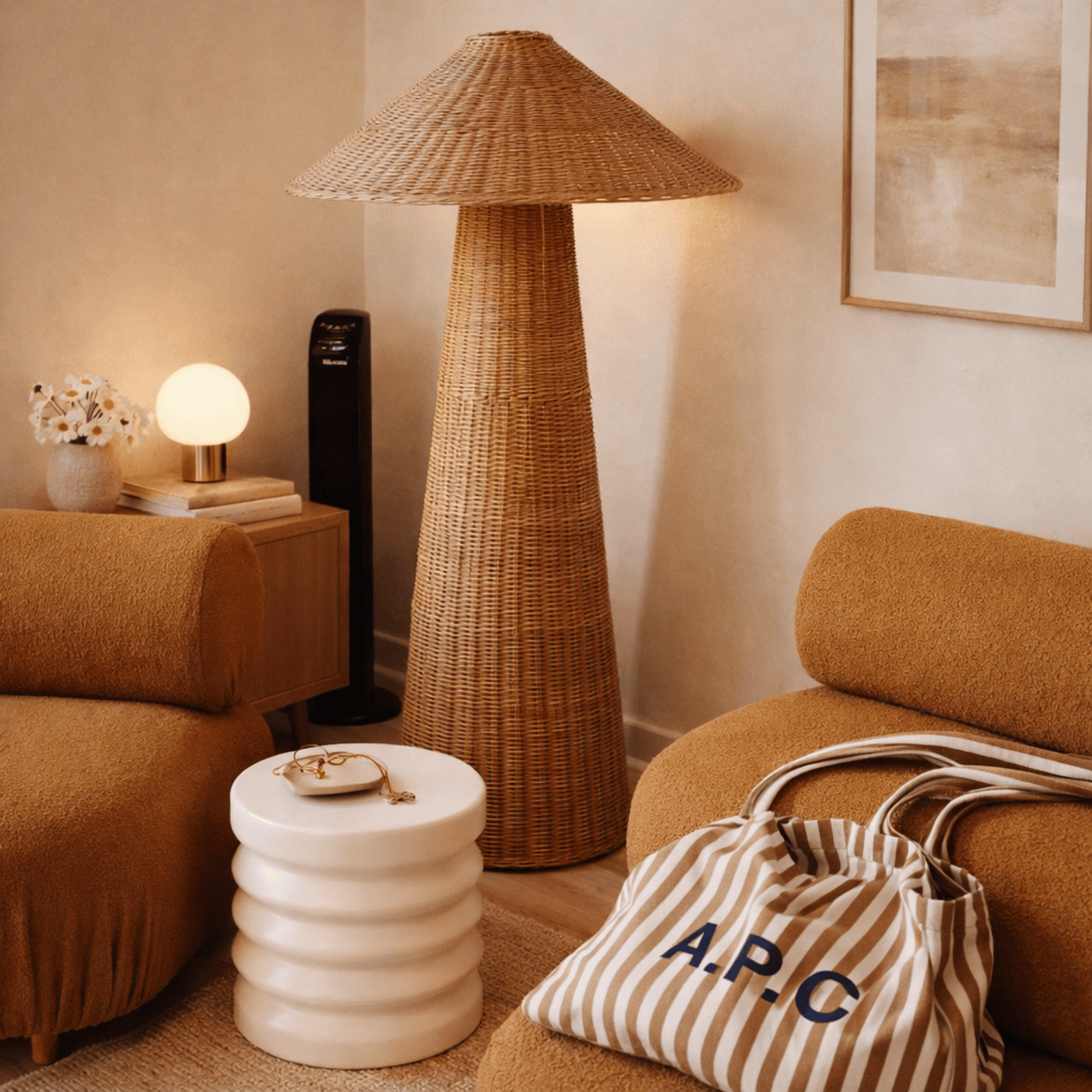 Living room with wicker floor lamp, striped bag, and brown sofa.