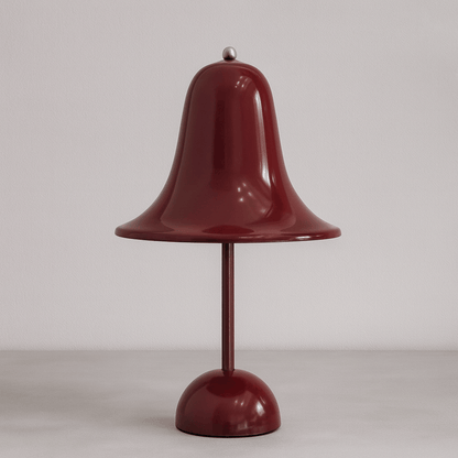 Red bell-shaped lamp on a plain background
