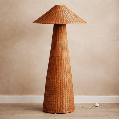 Wicker floor lamp against a beige wall