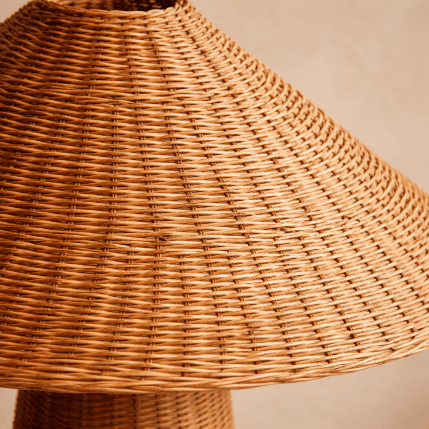 Close-up of a wicker lampshade on a beige background