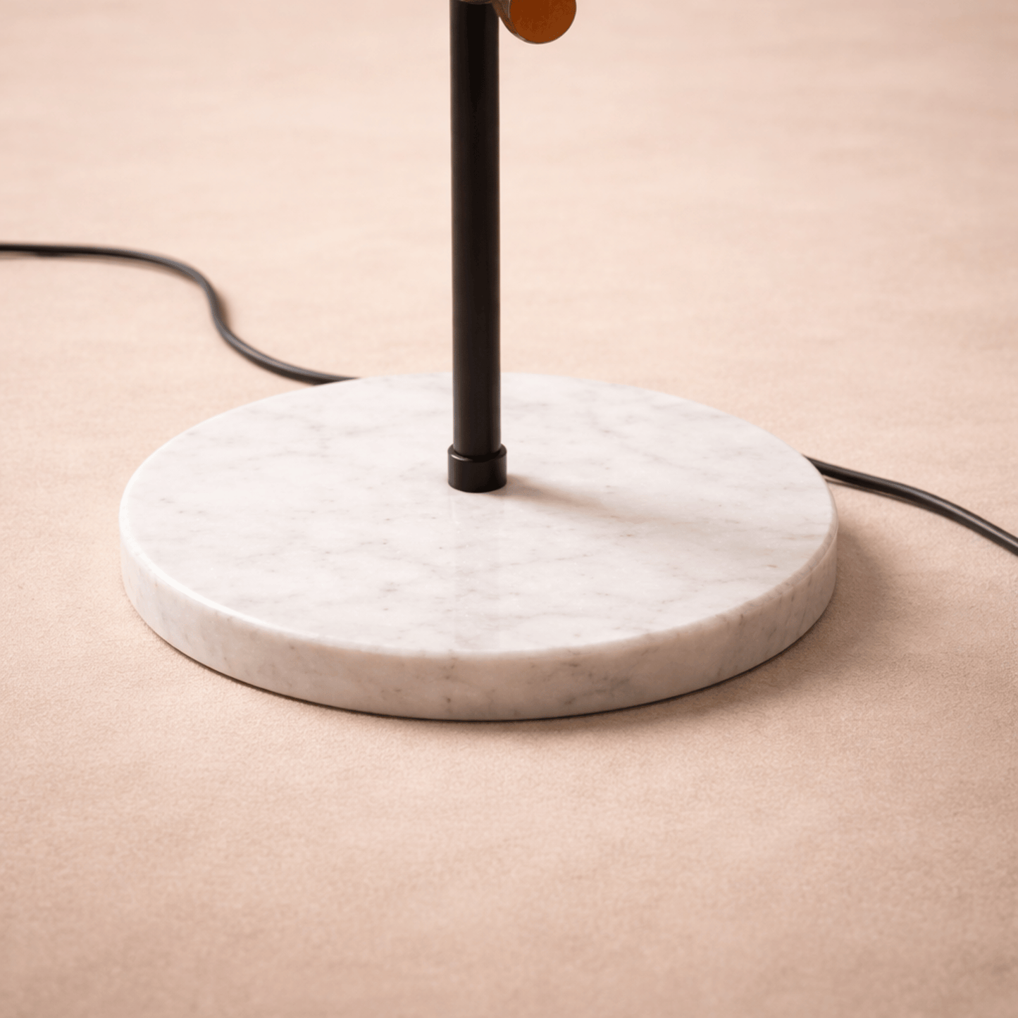 Table lamp with marble base on a beige surface