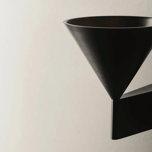 Black wall-mounted shelf against a beige background