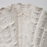 Close-up of a textured white surface with wavy patterns