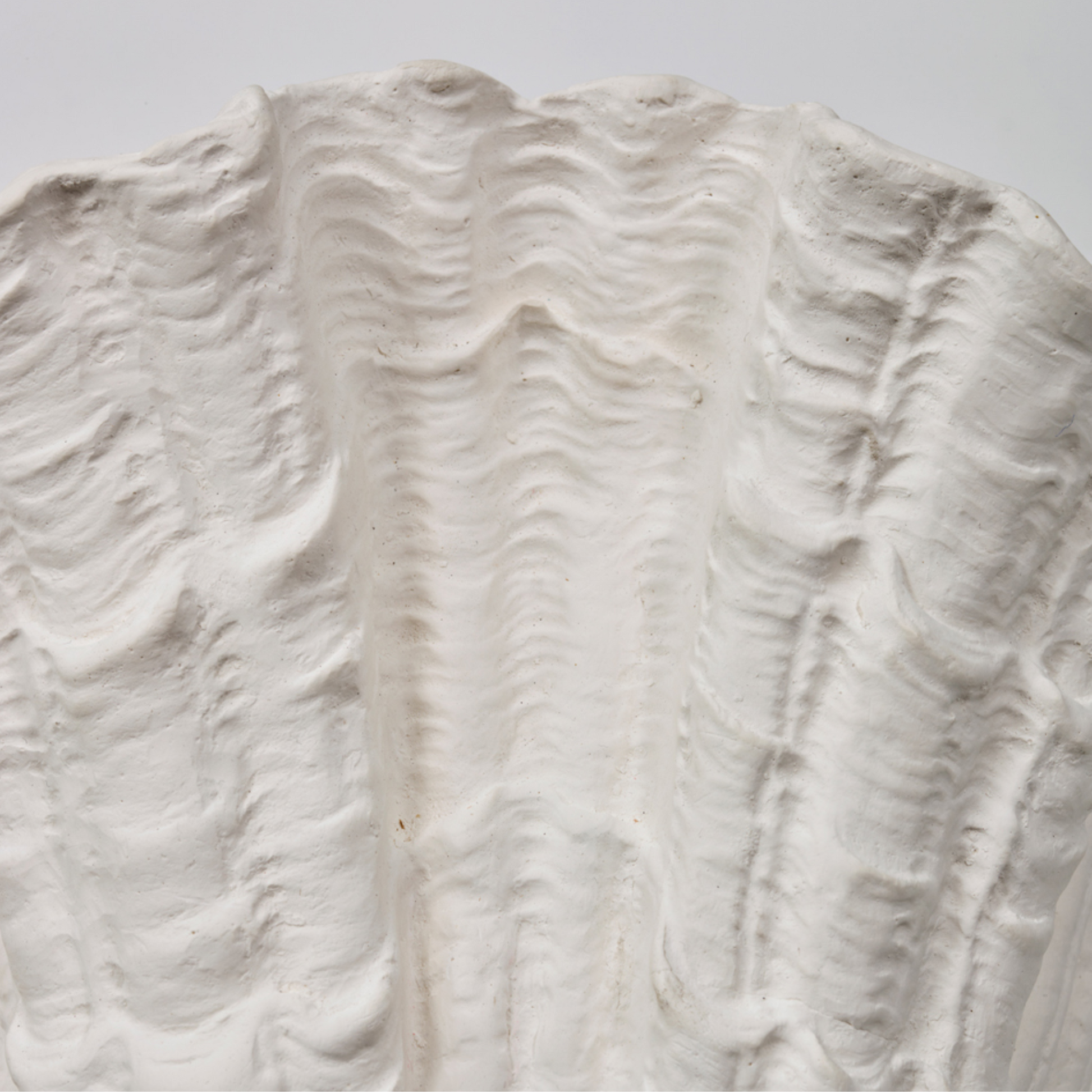 Close-up of a textured white surface with wavy patterns