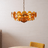 Gold chandelier with circular design on a neutral background