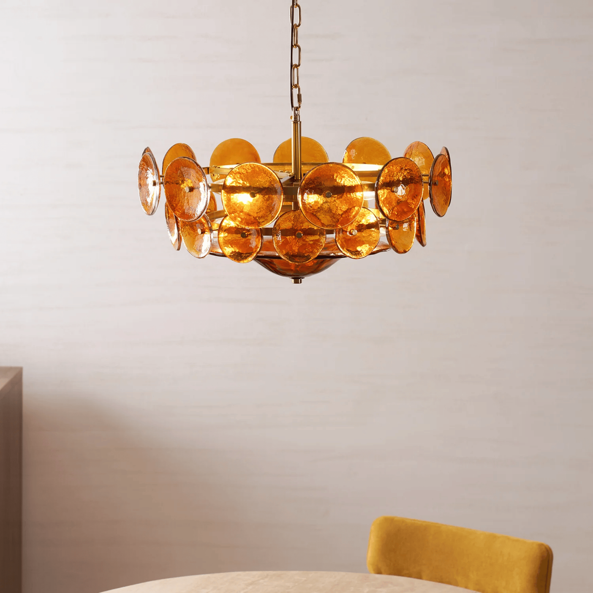 Gold chandelier with circular design on a neutral background