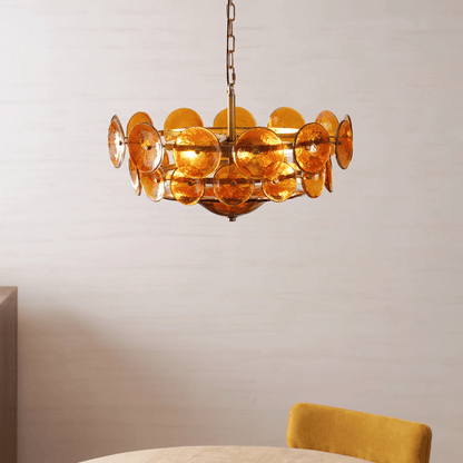 Gold chandelier with circular design on a neutral background