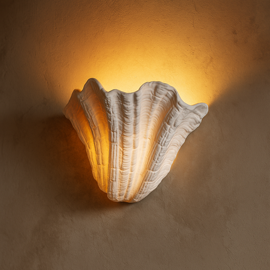 Shell-shaped wall light fixture on a textured wall