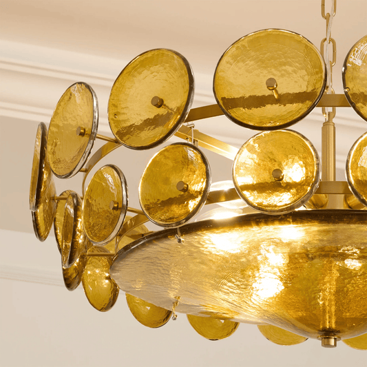 Gold chandelier with circular design on a white ceiling