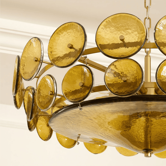 Gold chandelier with circular design on a white background