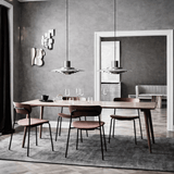 Modern dining room with wooden table and chairs against a gray wall.
