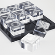 Clear acrylic blocks with letter 'X' and 'O' on a black tray
