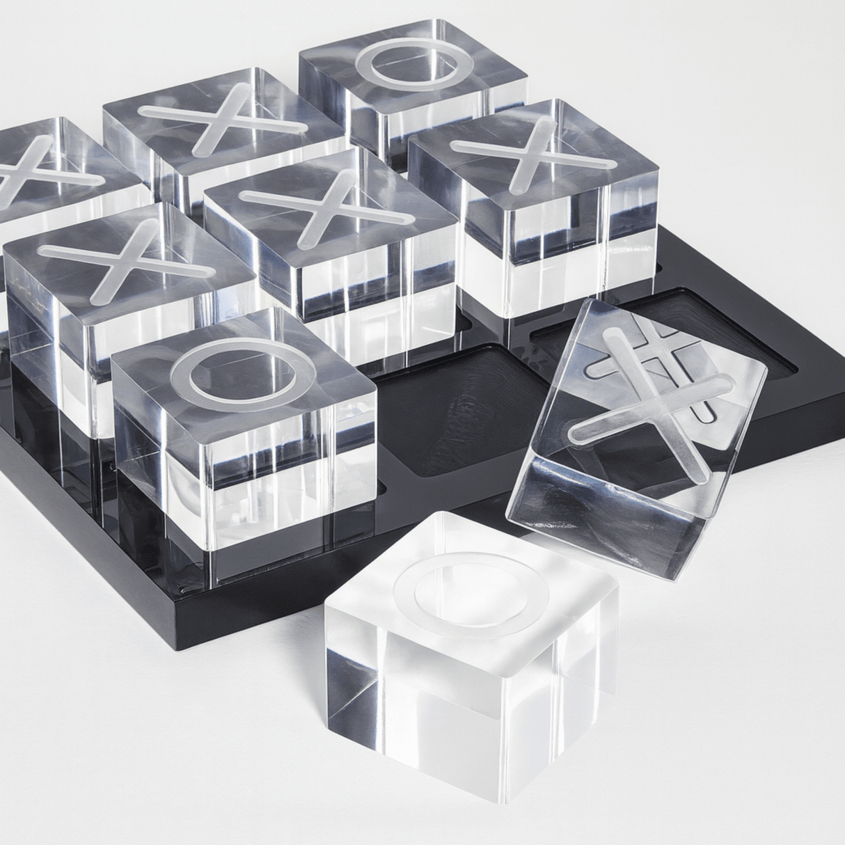 Clear acrylic blocks with letter 'X' and 'O' on a black tray