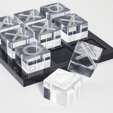 Clear acrylic blocks with letter 'X' and 'O' on a black tray