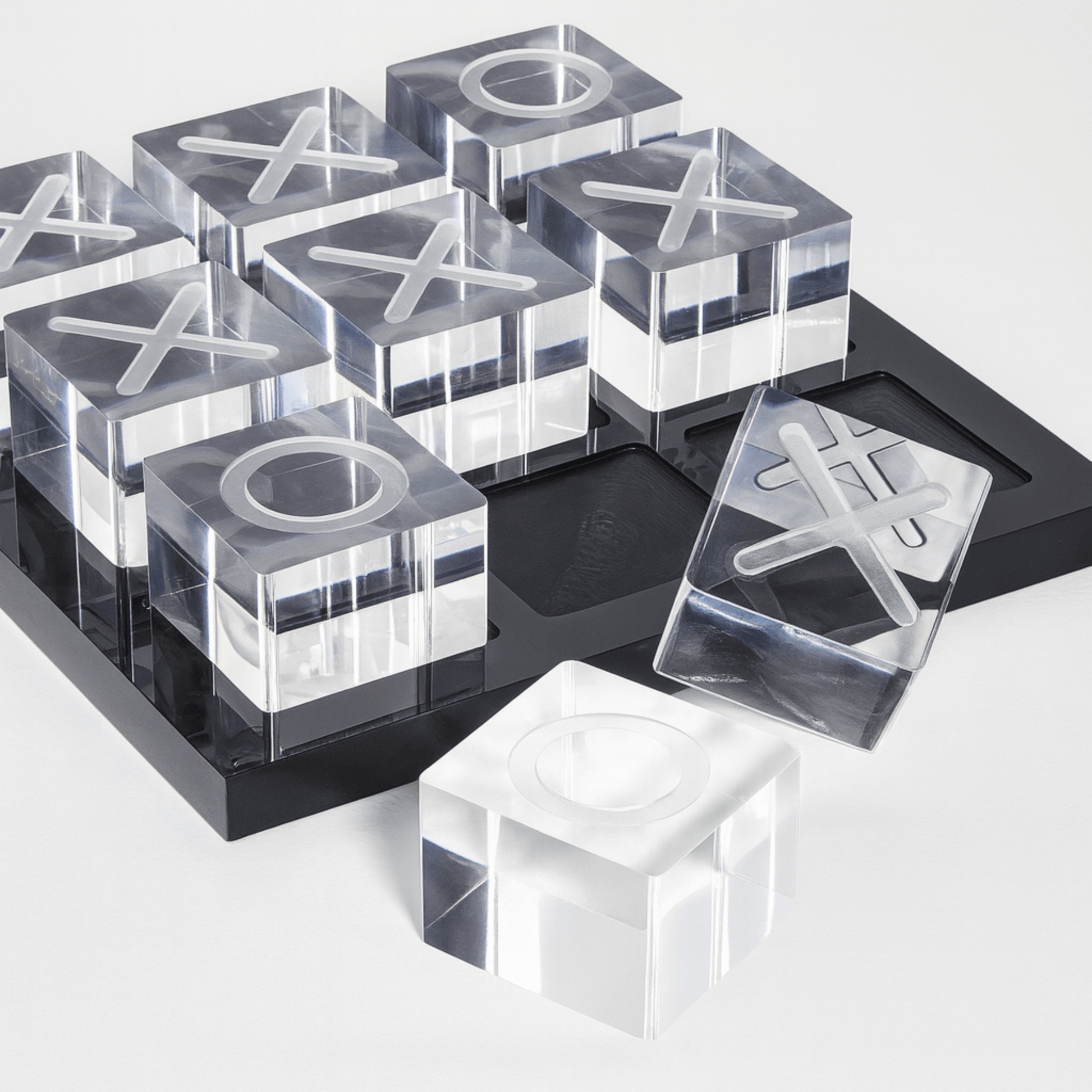Clear acrylic blocks with letter 'X' and 'O' on a black tray