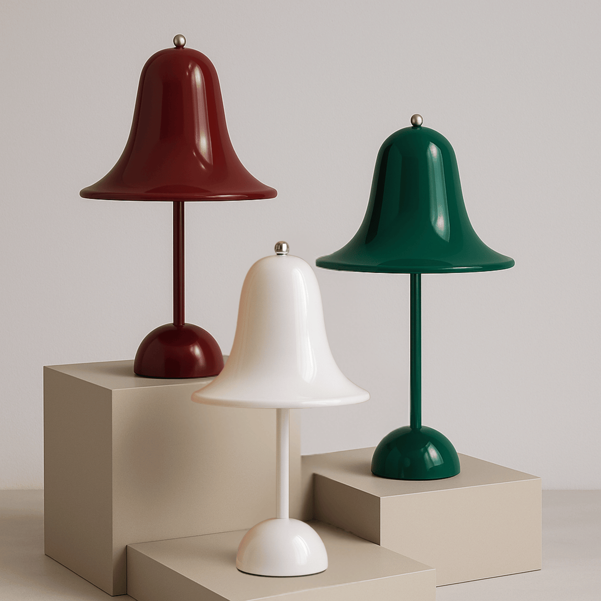 Three table lamps in red, white, and green on beige stands against a light gray background