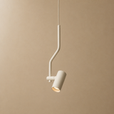 A modern pendant light with a matte off-white finish, featuring a bent arm design and a cylindrical shade, shown against a solid beige background.