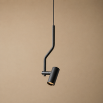 A modern black pendant light with a curved, bent metal arm and a cylindrical shade, shown hanging against a solid beige background.