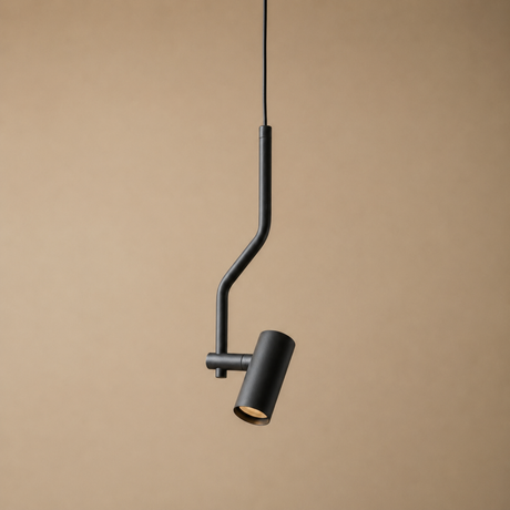 A modern black pendant light with a curved, bent metal arm and a cylindrical shade, shown hanging against a solid beige background.