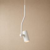 A modern white pendant light with a curved, snake-like arm and a cylindrical shade, shown against a solid beige background.